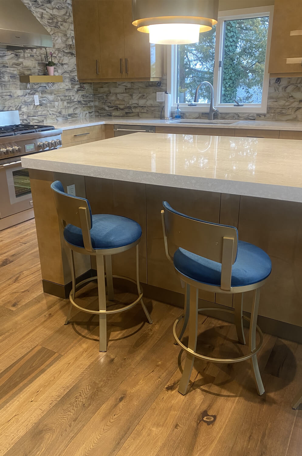 Wesley Allen's Bali Low Back Gold Counter Stools in Modern Kitchen