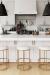 Wesley Allen's Nyx Modern Backless Gold Bar Stools in Modern White Kitchen